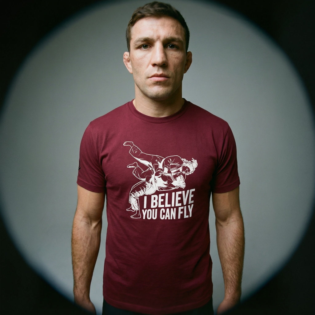 Athletic guy with cauliflower ear wearing Maroon T-Shirt with sign "I believe you can fly" depicting judo throw. Front